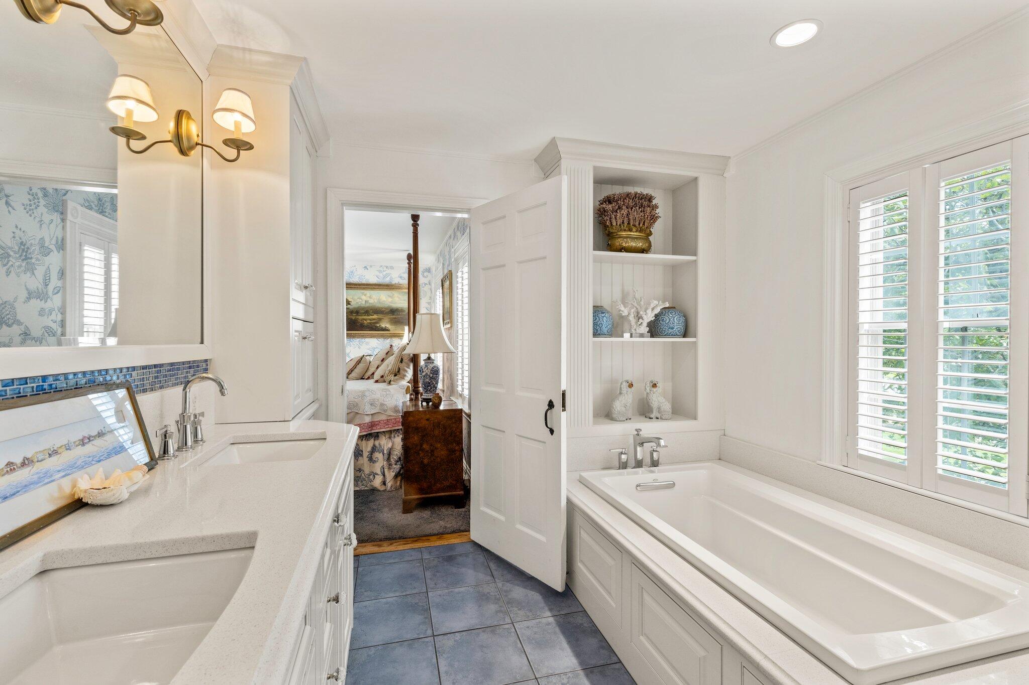 4259 Main Street Barnstable, MA 02630 - Photo 37 of 69 a bathroom with a tub a sink and a large mirror