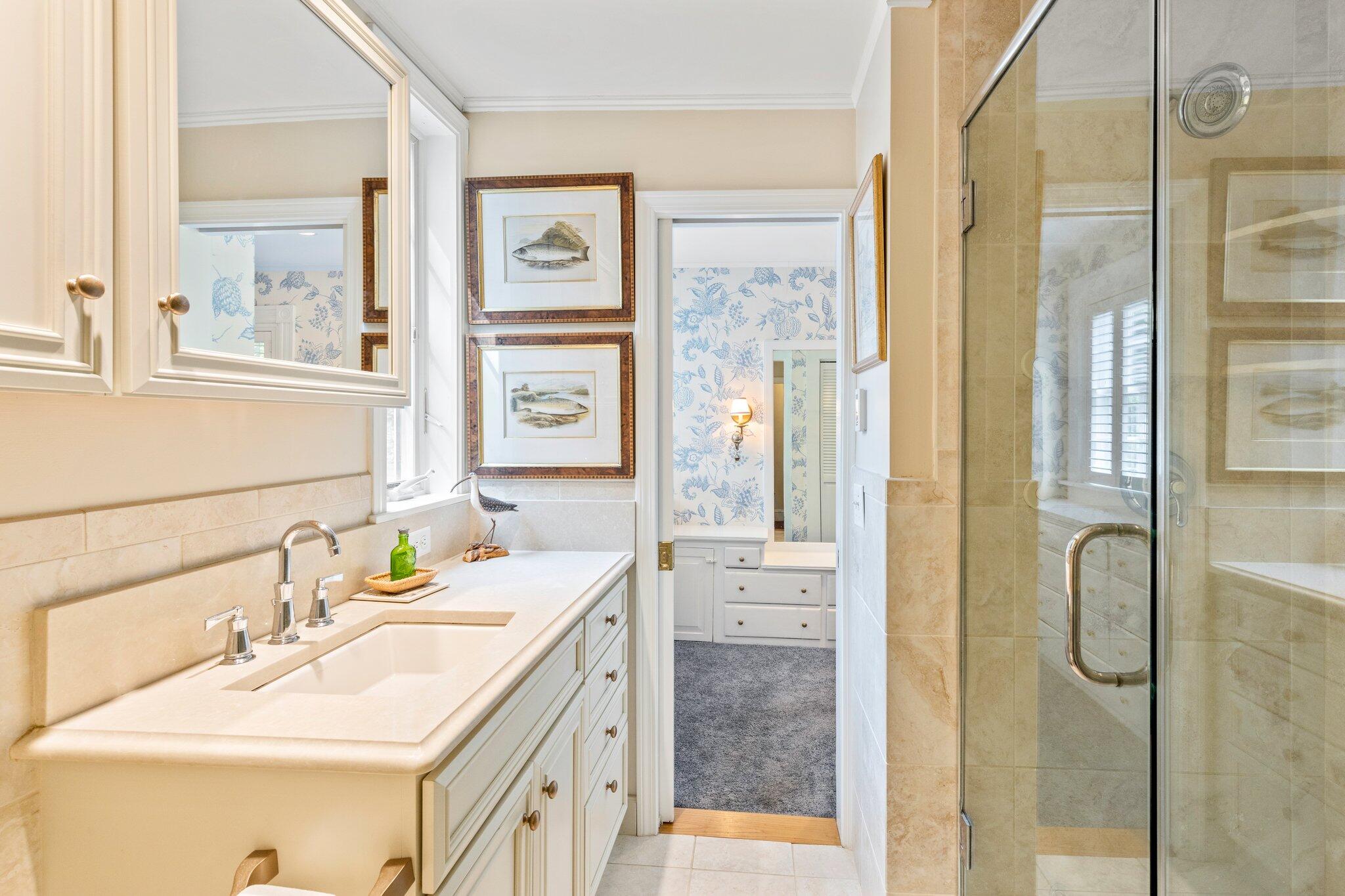 4259 Main Street Barnstable, MA 02630 - Photo 40 of 69 a bathroom with a double vanity sink mirror and shower