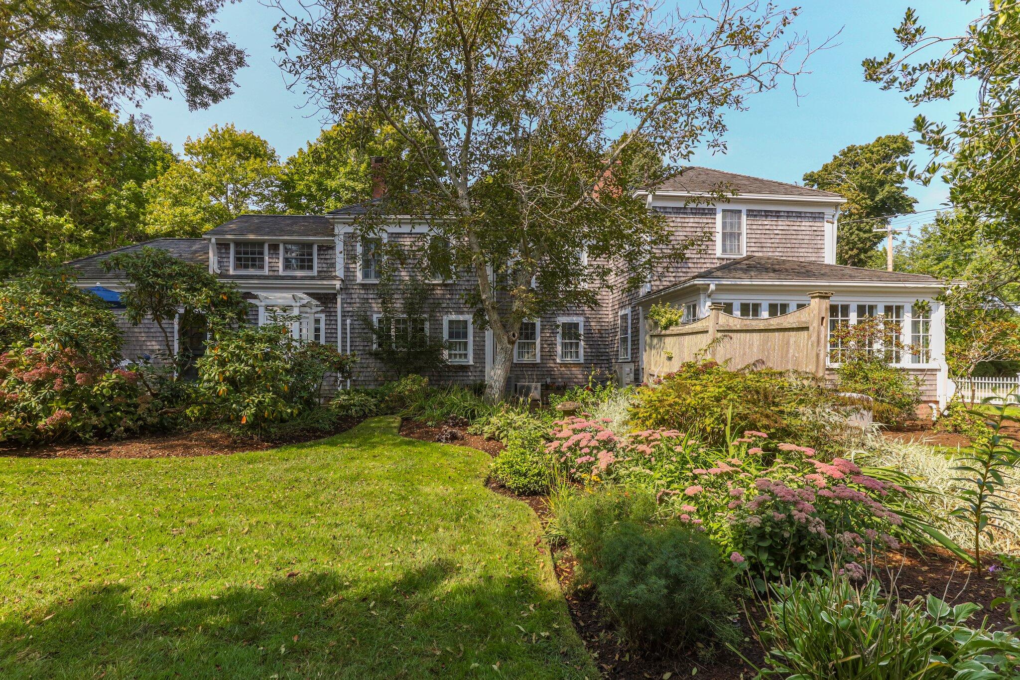 4259 Main Street Barnstable, MA 02630 - Photo 4 of 69 a front view of a house with a yard and trees