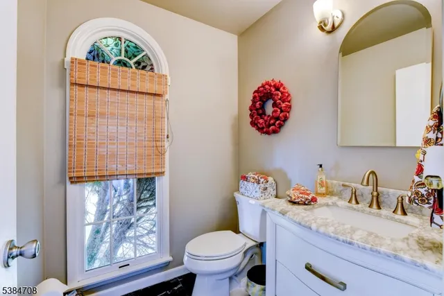 a bathroom with a toilet sink and mirror