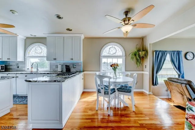 a kitchen with a dining table chairs and view living room