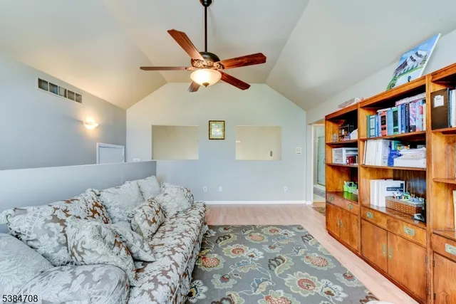 a bedroom with bed and a book shelf