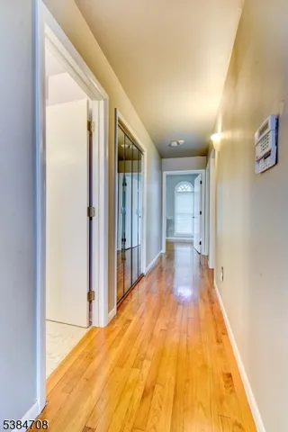 a view of a big room with wooden floor and a bathroom