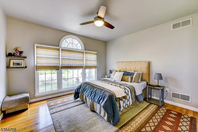a bedroom with a bed and a large window