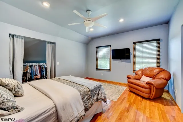 a bedroom with bed and a flat screen tv