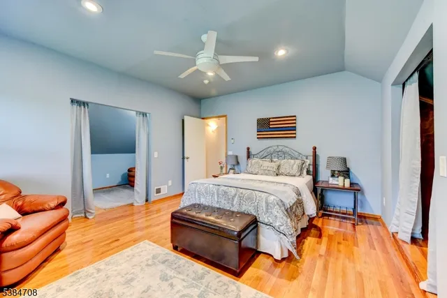 a spacious bedroom with a bed and a couch