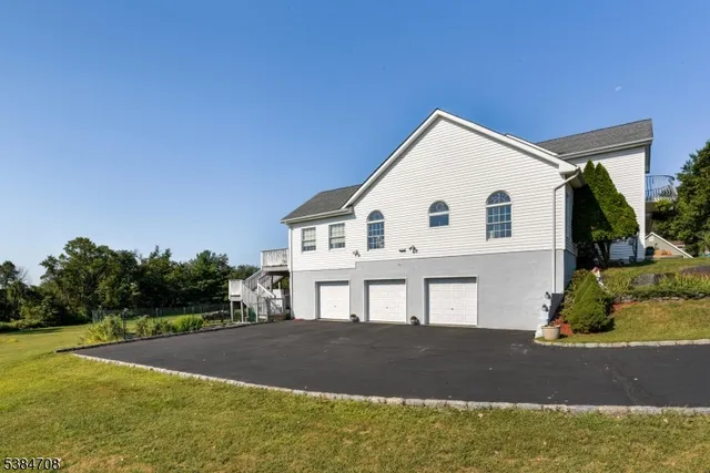 a aerial view of a house with swimming pool and large trees