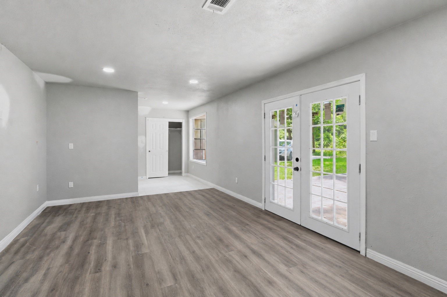 1910 Riverwood Trail Spring, TX 77386 - Photo 4 of 11 a view of an empty room with wooden floor and a window