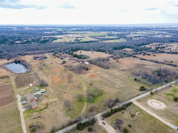 an aerial view of residential houses with outdoor space
