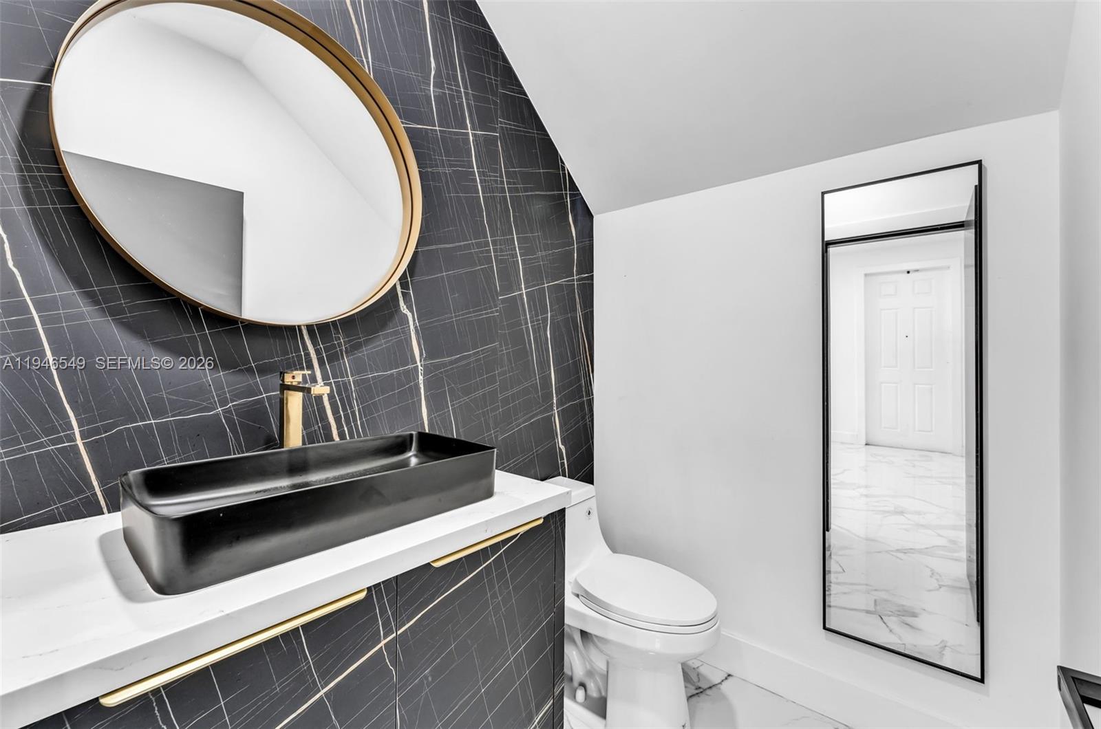 23601 Southwest 112 Court Homestead, FL 33032 - Photo 11 of 61 a bathroom with a toilet a sink and mirror