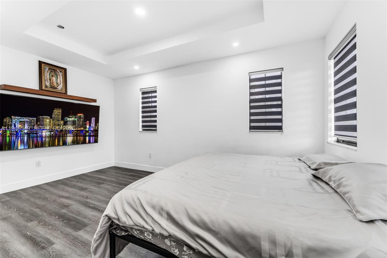 23601 Southwest 112 Court Homestead, FL 33032 - Photo 14 of 61 a bedroom with a bed and a book shelf