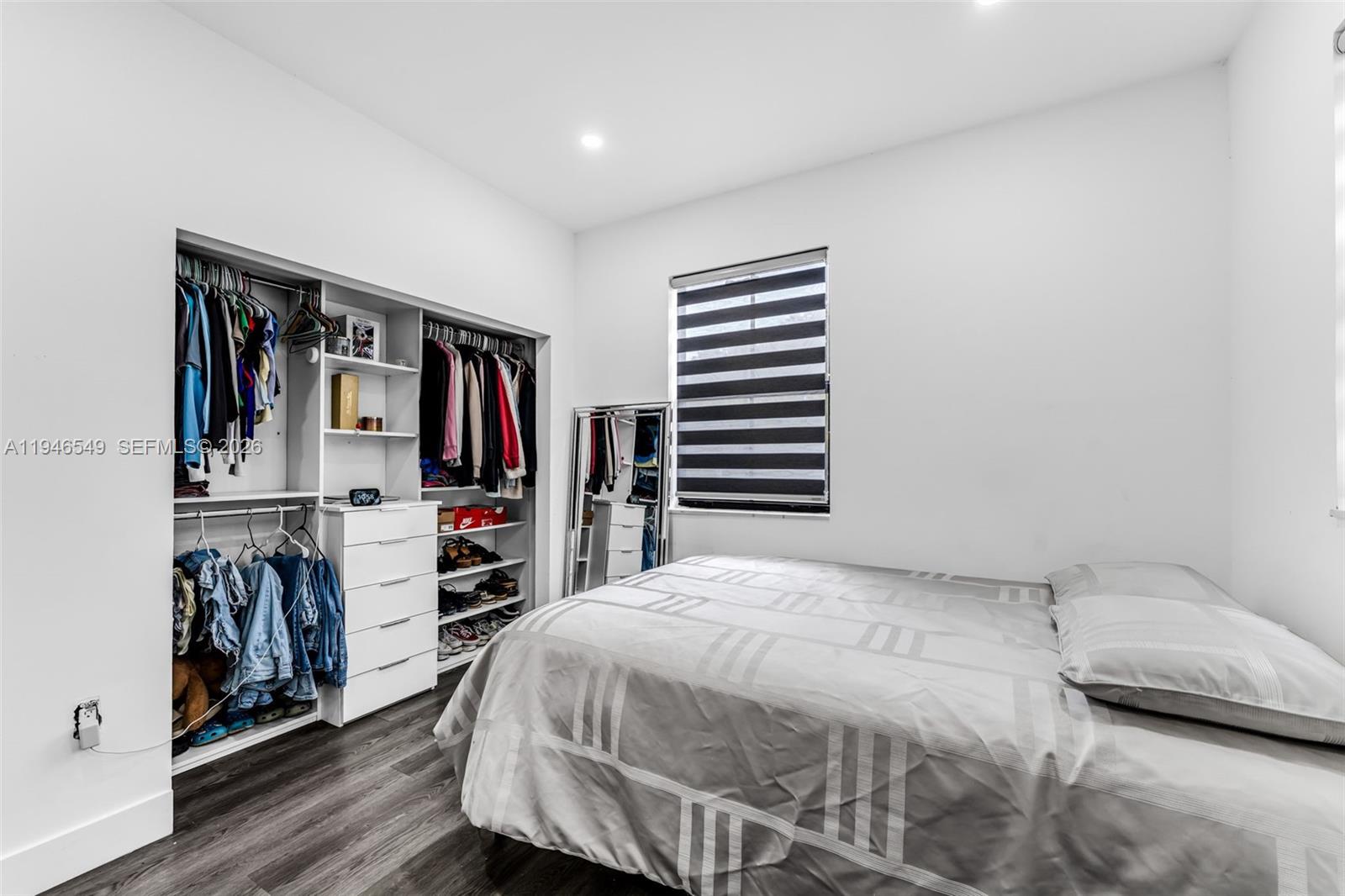 23601 Southwest 112 Court Homestead, FL 33032 - Photo 20 of 61 a bedroom with a bed and a book shelf