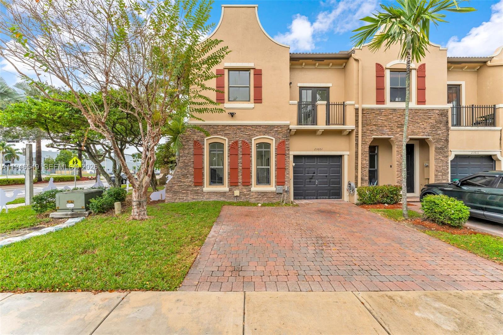 23601 Southwest 112 Court Homestead, FL 33032 - Photo 30 of 61 a front view of a house with garden and parking
