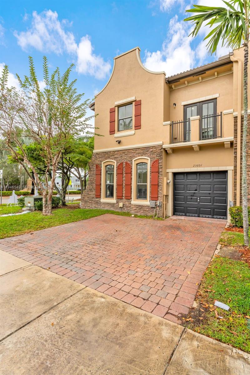 23601 Southwest 112 Court Homestead, FL 33032 - Photo 37 of 61 a front view of a house with a yard and garage