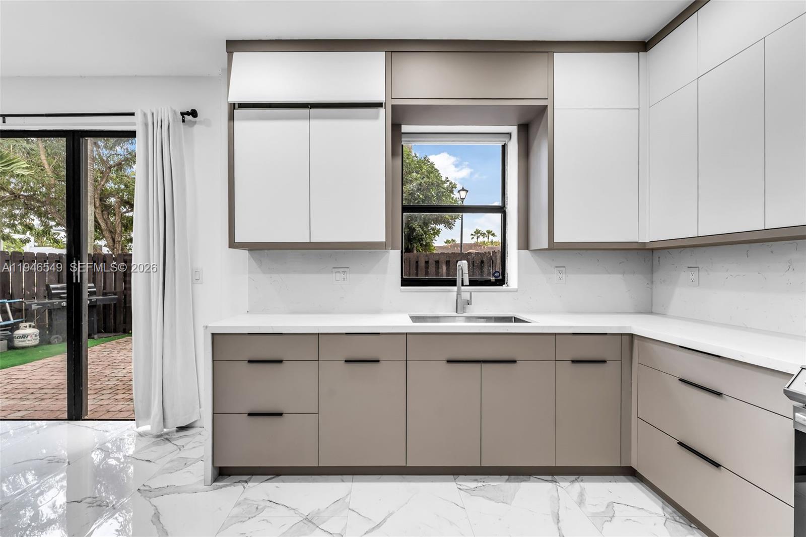 23601 Southwest 112 Court Homestead, FL 33032 - Photo 4 of 61 a kitchen with stainless steel appliances a sink and cabinets