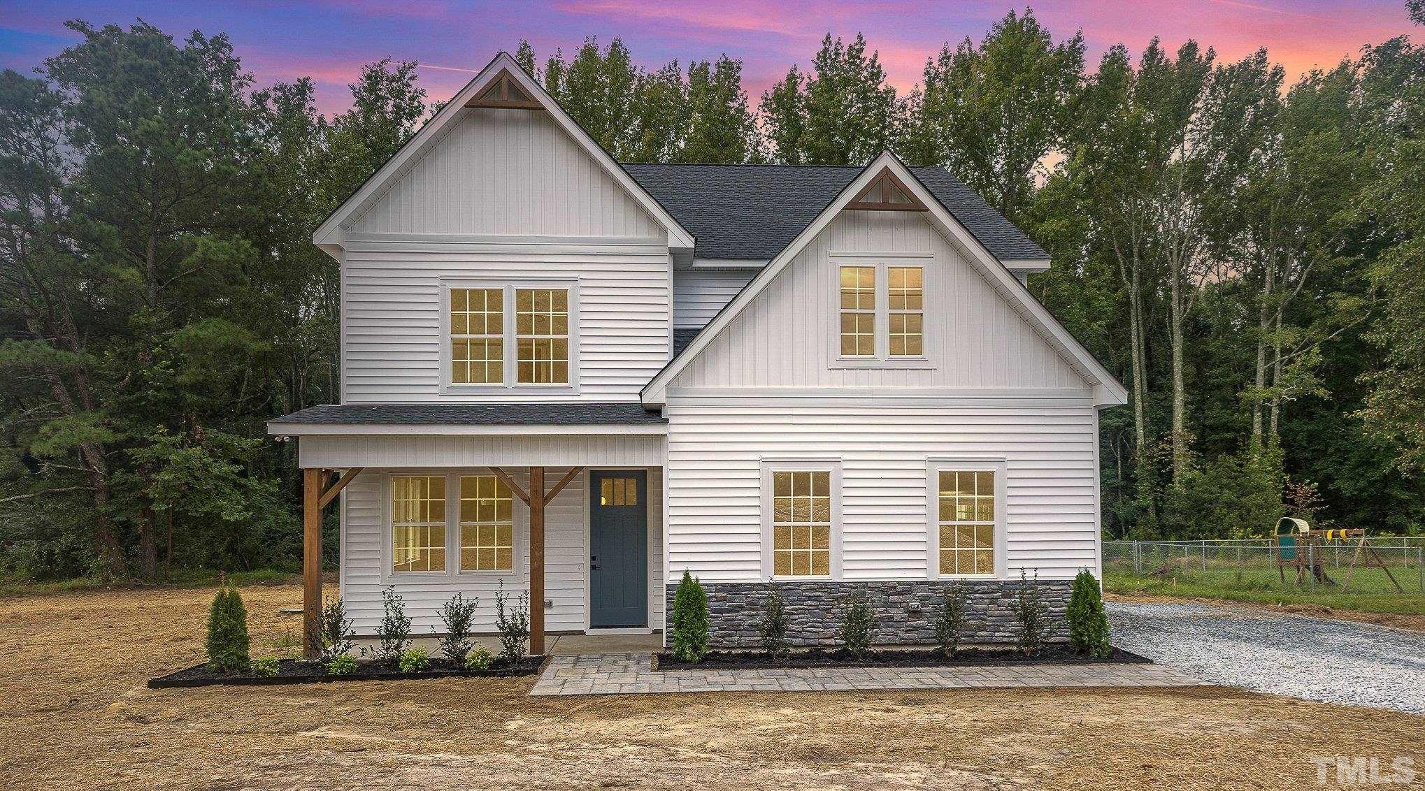 1291 Massengill Pond Road Angier, NC 27501 - Photo 1 of 45 a front view of a house with a yard and garage