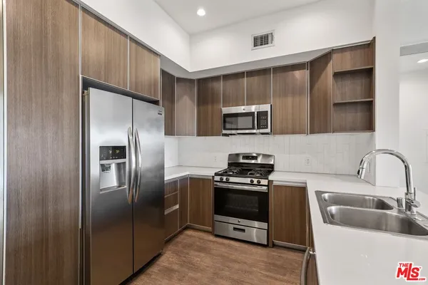 a kitchen with a refrigerator sink and stove