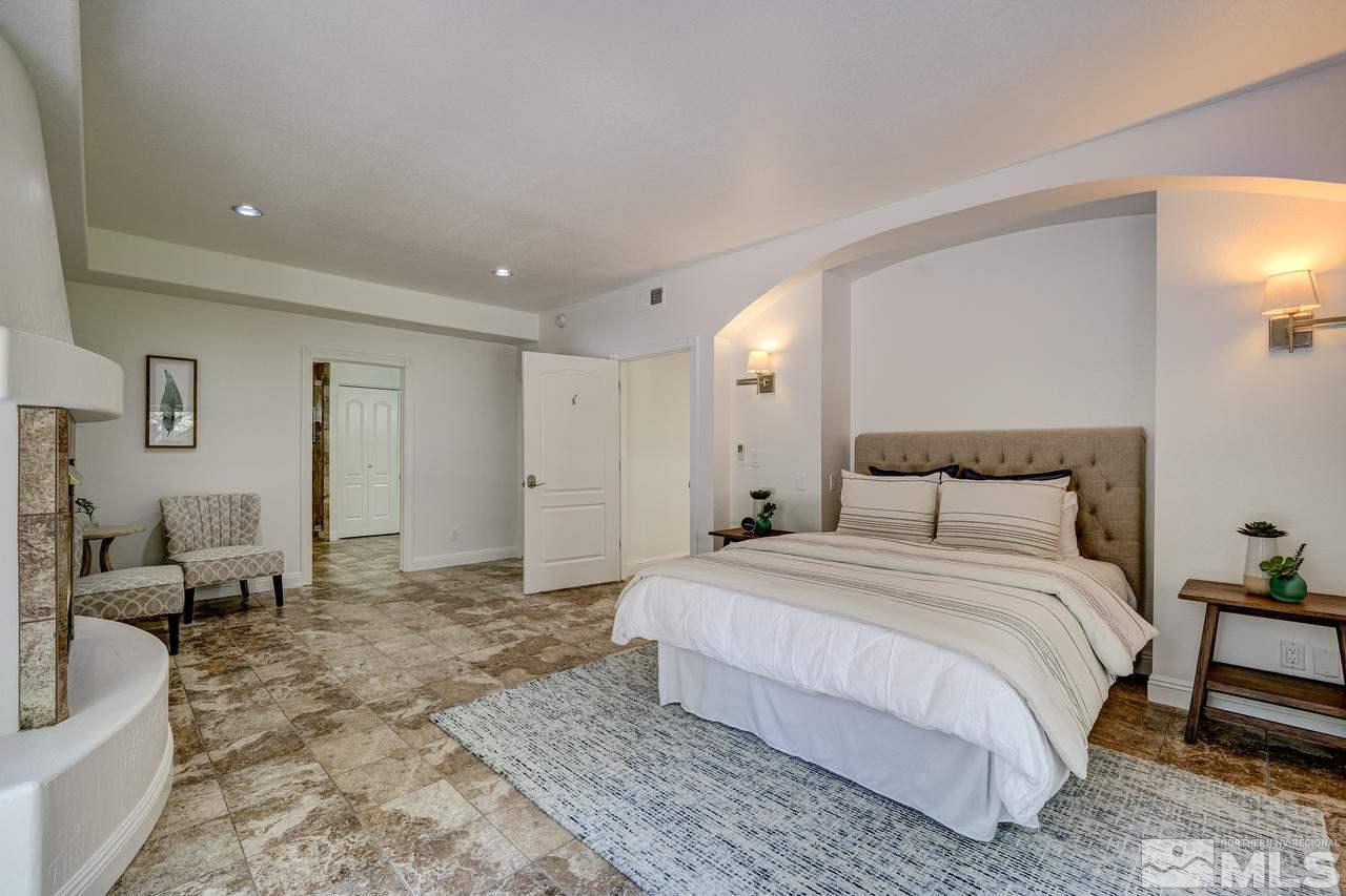 4286 Caughlin Parkway Reno, NV 89519 - Photo 16 of 25 a spacious bedroom with a bed a couch and a view of bedroom
