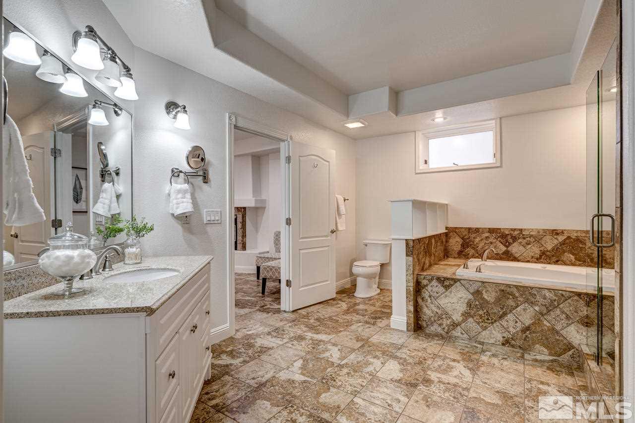 4286 Caughlin Parkway Reno, NV 89519 - Photo 17 of 25 a spacious bathroom with a granite countertop sink a toilet and shower