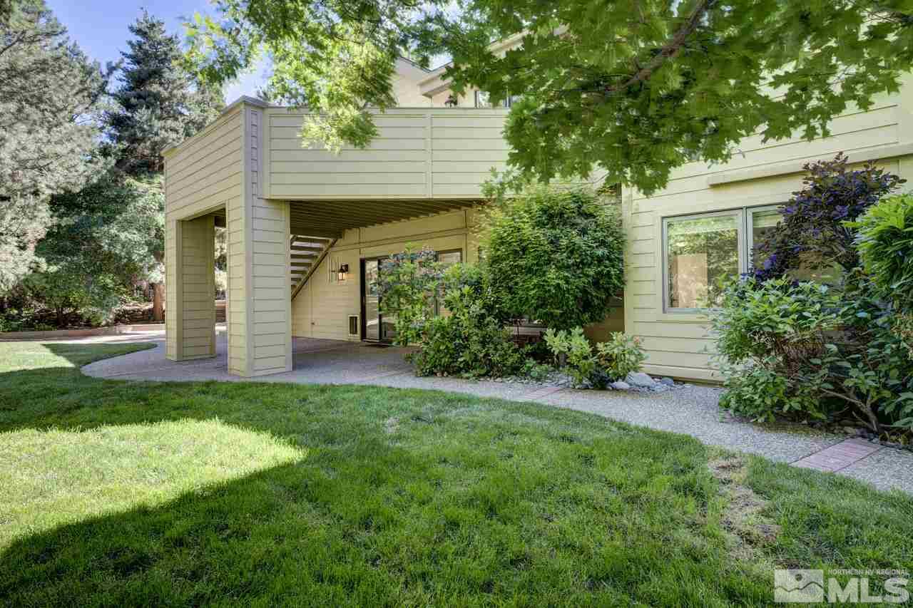 4286 Caughlin Parkway Reno, NV 89519 - Photo 24 of 25 a front view of a house with a yard and garage