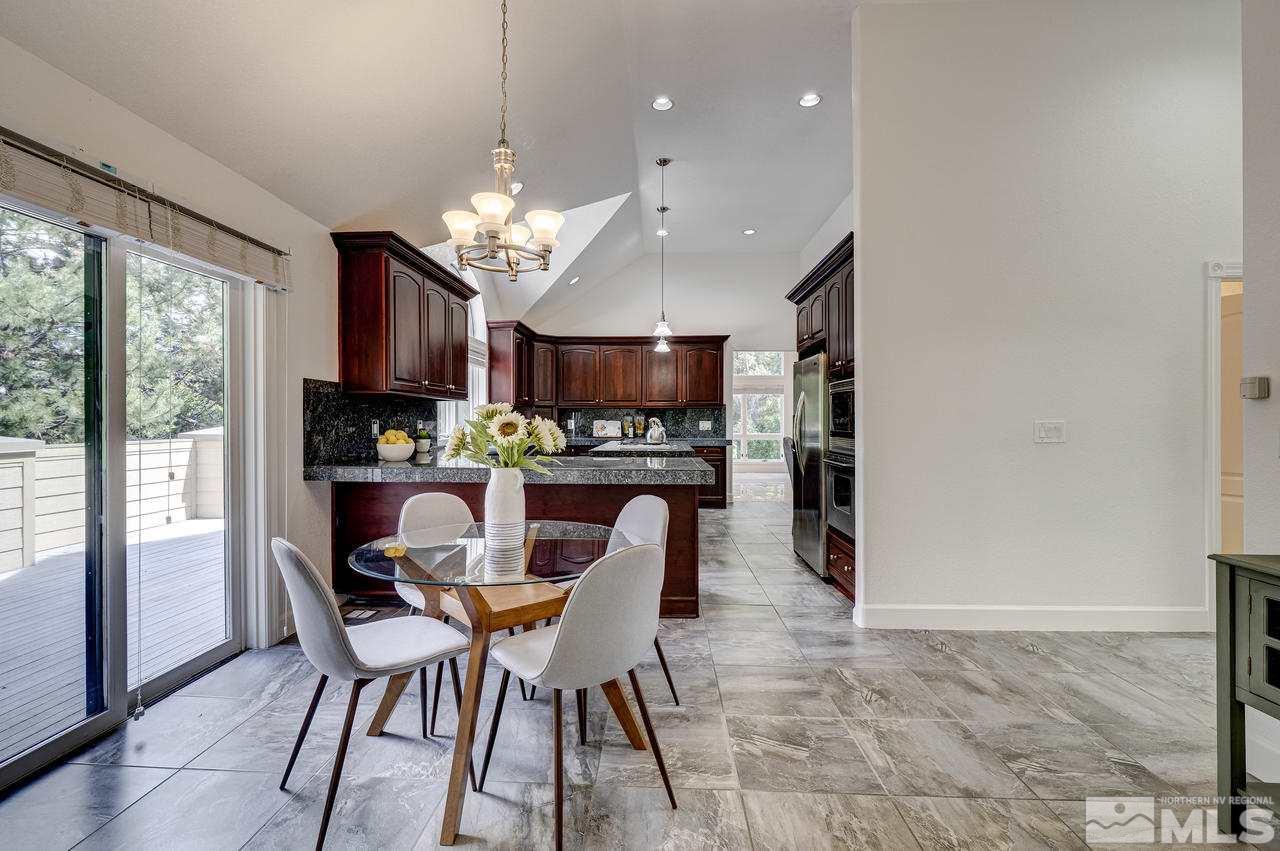 4286 Caughlin Parkway Reno, NV 89519 - Photo 9 of 25 a dining room with furniture a chandelier and window