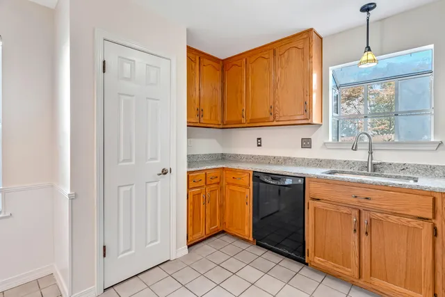 a kitchen with stainless steel appliances granite countertop a sink and a window