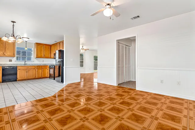 a view of empty room with wooden floor