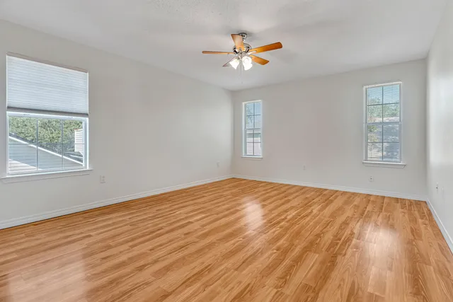a bathroom with double vanity sinks a vanity a lamp and a mirror