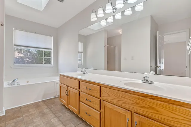 a bathroom with a sink double vanity and a mirror