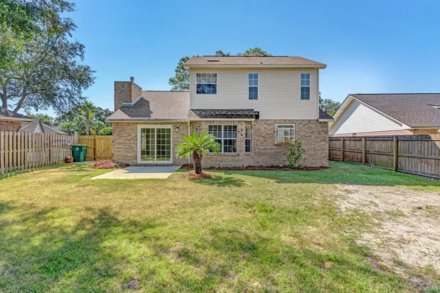 a view of a yard with plants and trees