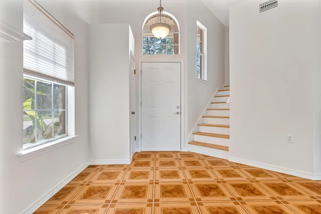 a view of a room with wooden floor windows and entryway
