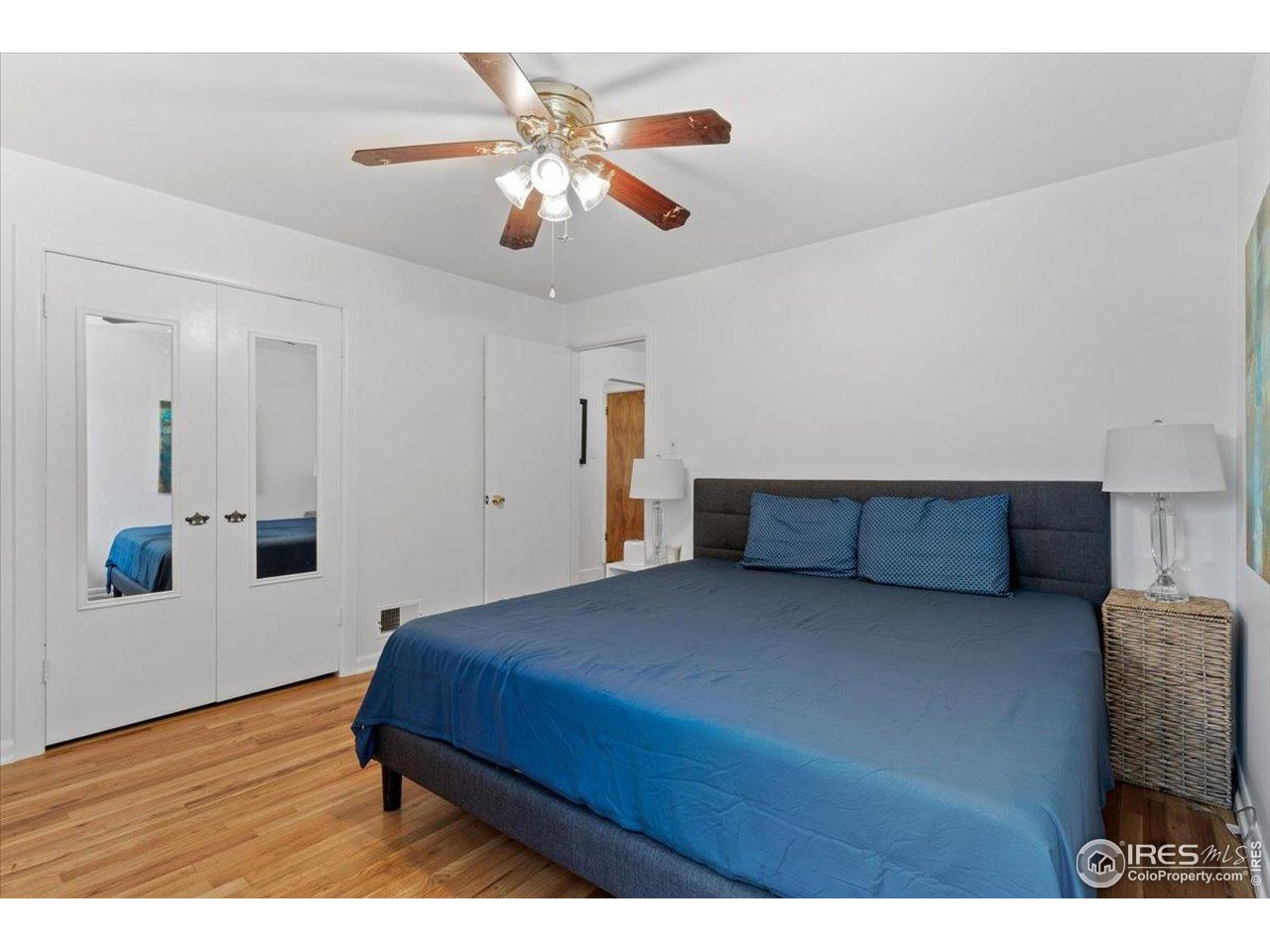 4125 Pierce Street Wheat Ridge, CO 80033 - Photo 16 of 45 a bedroom with a bed and a chandelier