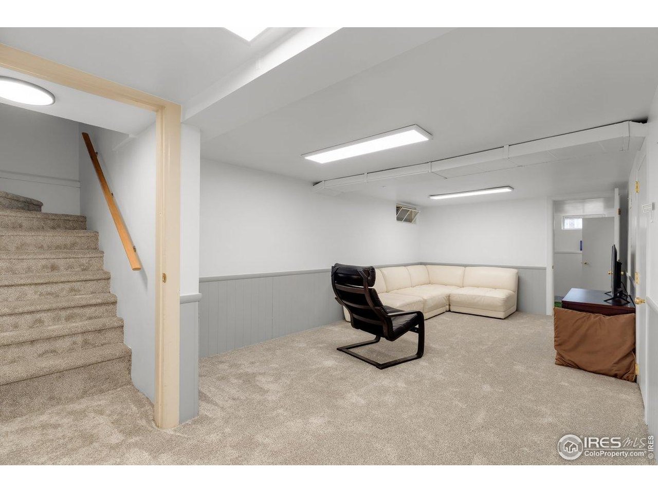 4125 Pierce Street Wheat Ridge, CO 80033 - Photo 24 of 45 a living room with furniture and a lamp