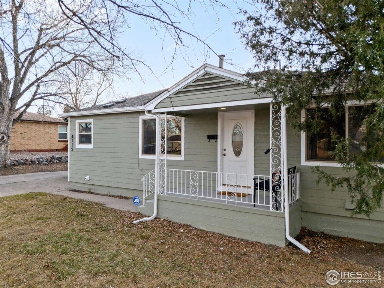 4125 Pierce Street Wheat Ridge, CO 80033 - Photo 4 of 45 a view of a house with a yard and large tree
