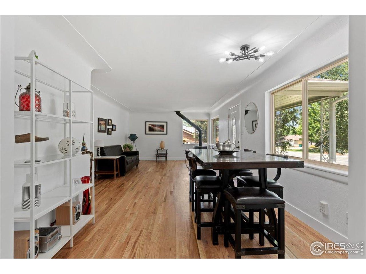 4125 Pierce Street Wheat Ridge, CO 80033 - Photo 10 of 45 a view of a dining room with furniture and wooden floor