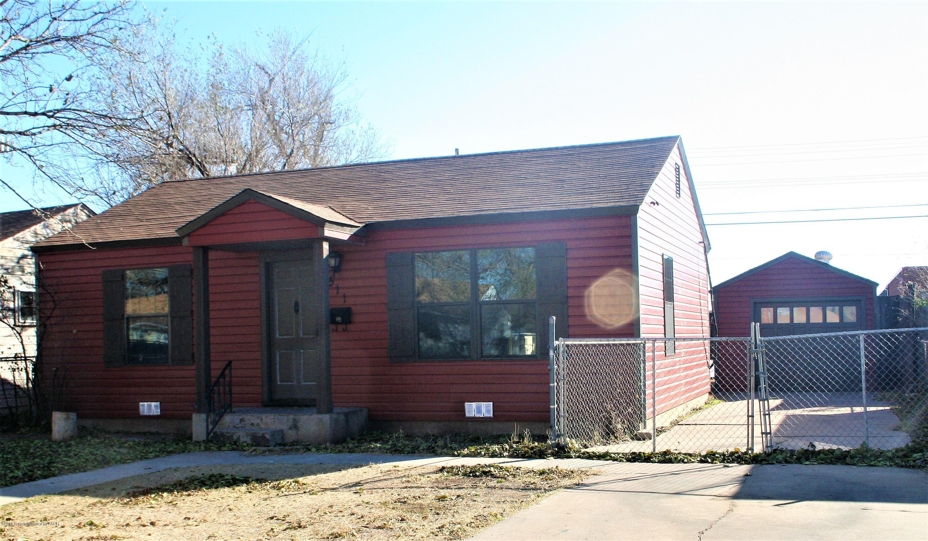 511 Southwest 45th Avenue Amarillo, TX 79110 - Photo 1 of 17 a front view of a house with garden