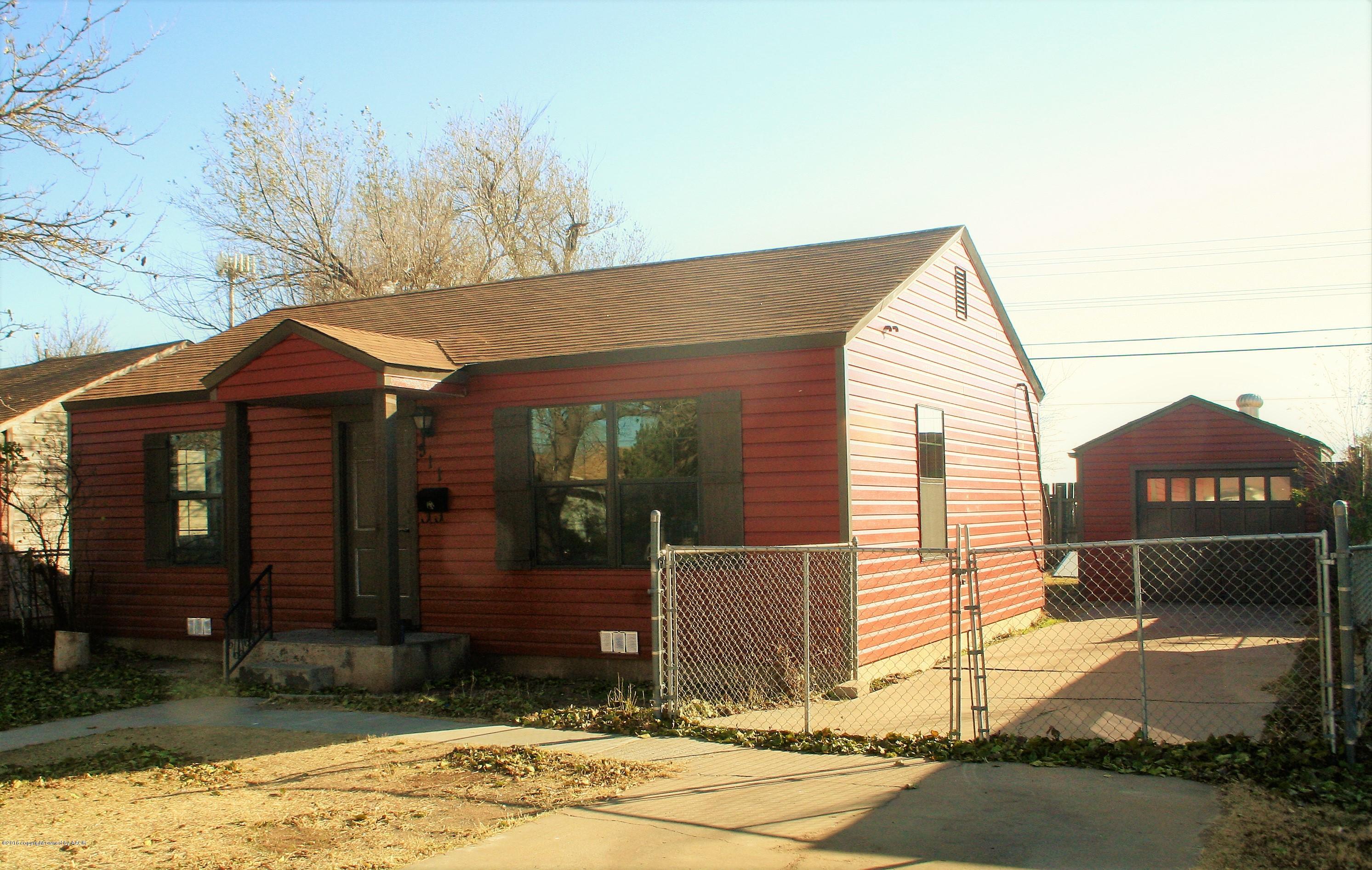 511 Southwest 45th Avenue Amarillo, TX 79110 - Photo 2 of 17 a front view of a house with a yard