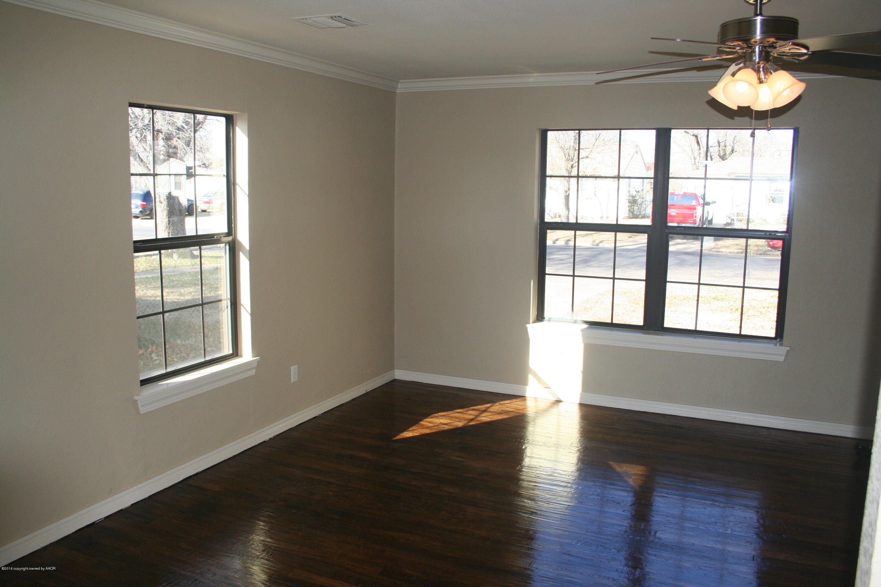 511 Southwest 45th Avenue Amarillo, TX 79110 - Photo 6 of 17 a view of an empty room with wooden floor and a window