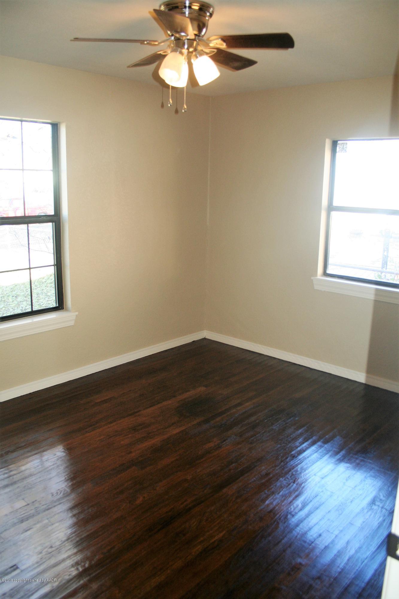 511 Southwest 45th Avenue Amarillo, TX 79110 - Photo 7 of 17 a view of a room with wooden floor and windows
