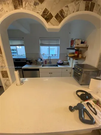a kitchen with a sink appliances and cabinets