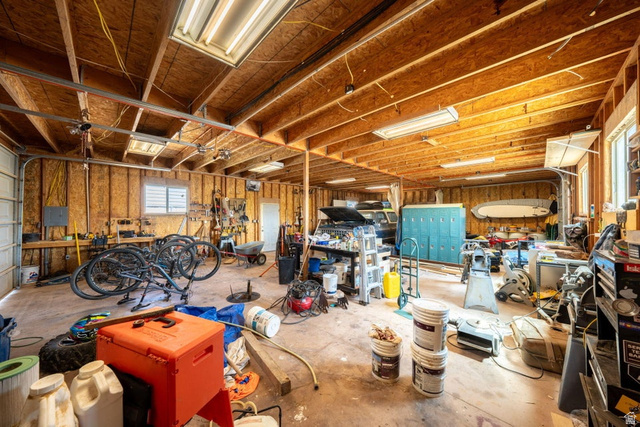 7776 Wagon Road East St. George, UT 84770 - Photo 60 of 76 Misc room with a garage, a workshop area, and unfinished concrete floors