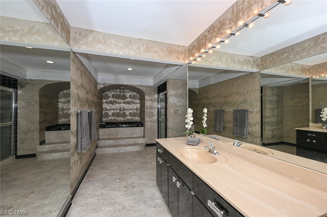 171 Granger Road, Unit 138 Medina, OH 44256 - Photo 24 of 31 Oversized en suite bathroom off of 3rd bedroom features a sleek jetted tub, walk in shower and an oversized vanity to meet all your storage needs.