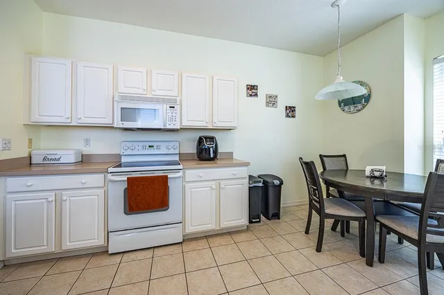 a kitchen with stainless steel appliances granite countertop a stove a sink a microwave and a refrigerator
