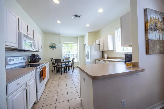 a kitchen with sink cabinets and stove top oven