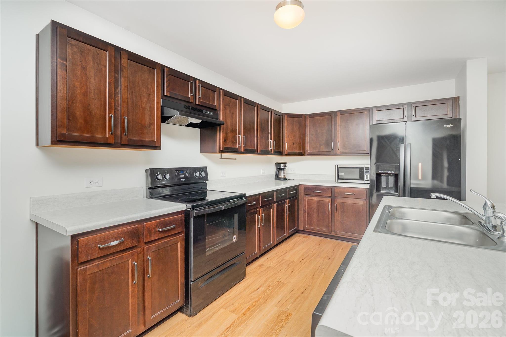 1211 Whitehall Hill Road York, SC 29745 - Photo 11 of 39 a kitchen with stainless steel appliances granite countertop a stove a sink dishwasher and a refrigerator with wooden cabinets