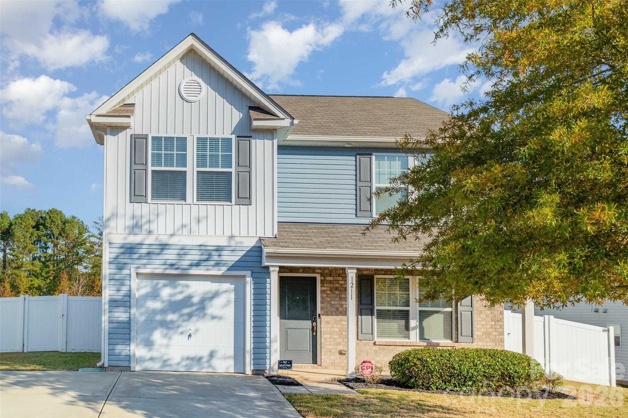 1211 Whitehall Hill Road York, SC 29745 - Photo 2 of 39 a view of a white house with large windows and a small yard