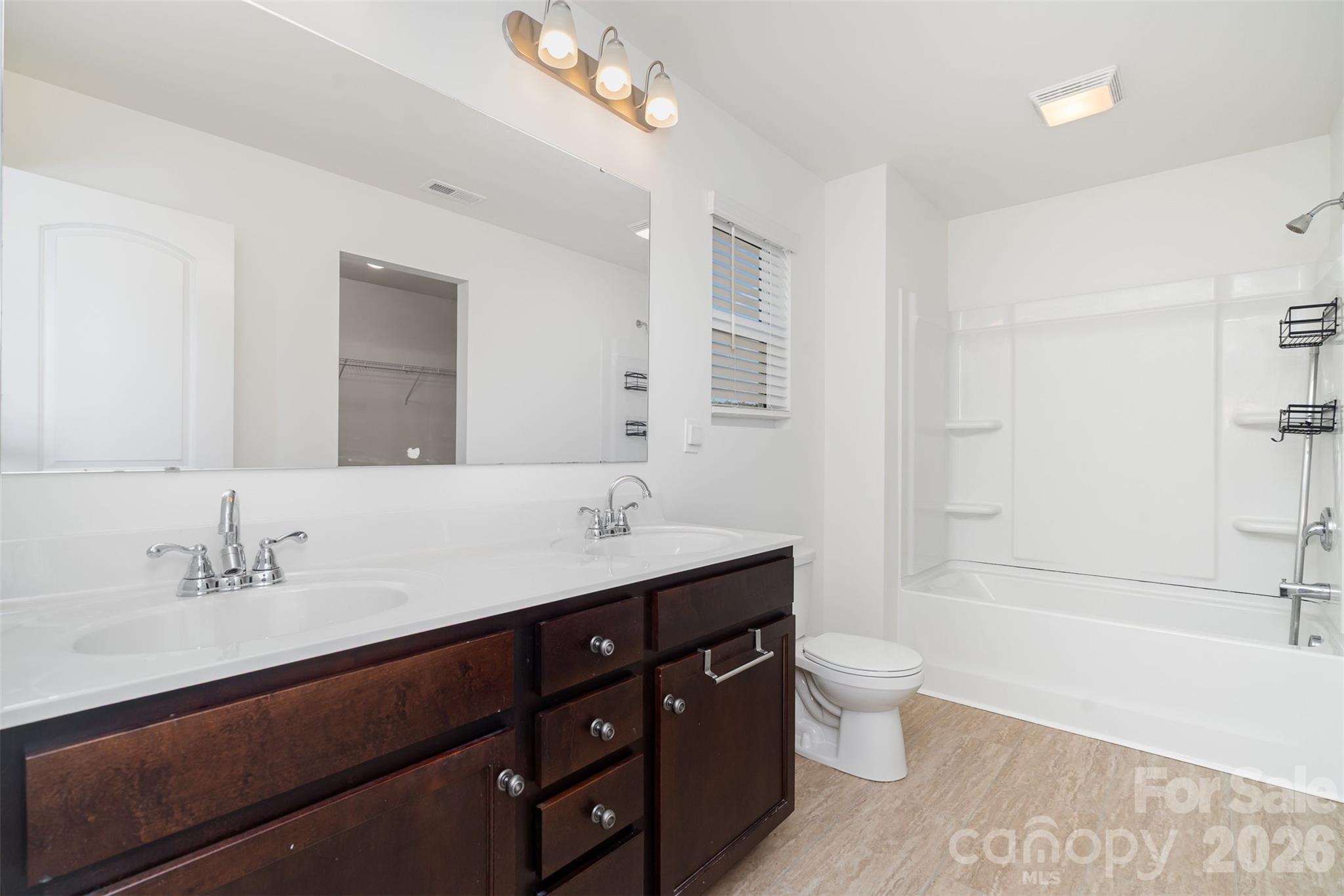 1211 Whitehall Hill Road York, SC 29745 - Photo 23 of 39 a bathroom with a double vanity sink toilet mirror and bathtub