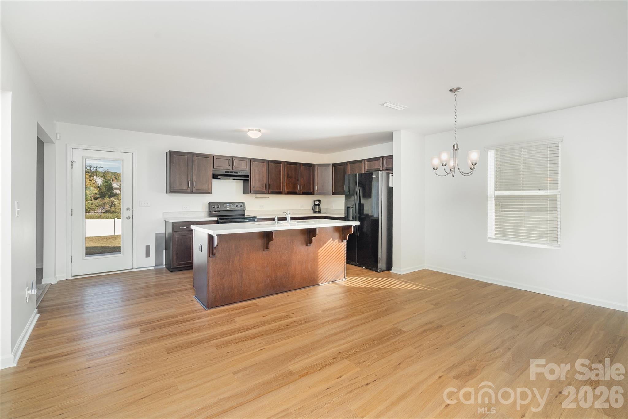 1211 Whitehall Hill Road York, SC 29745 - Photo 4 of 39 a large kitchen with stainless steel appliances granite countertop a stove a sink dishwasher and a refrigerator with wooden floor