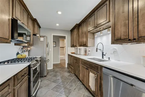 a kitchen with a sink stove and cabinets
