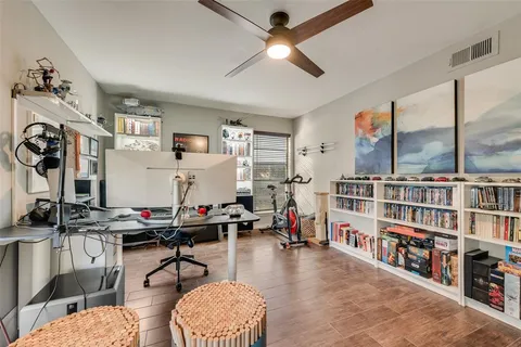 a living room with lots of furniture and book shelf